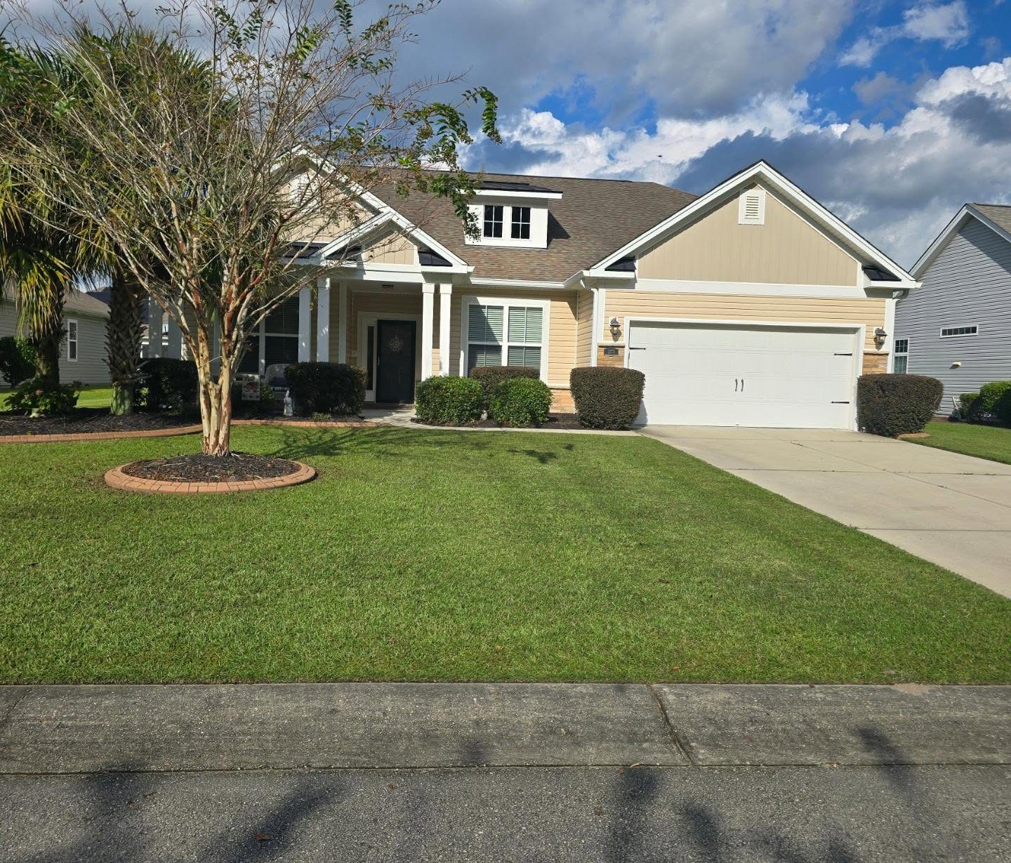 Manicured front lawn and landscaping at a coastal home