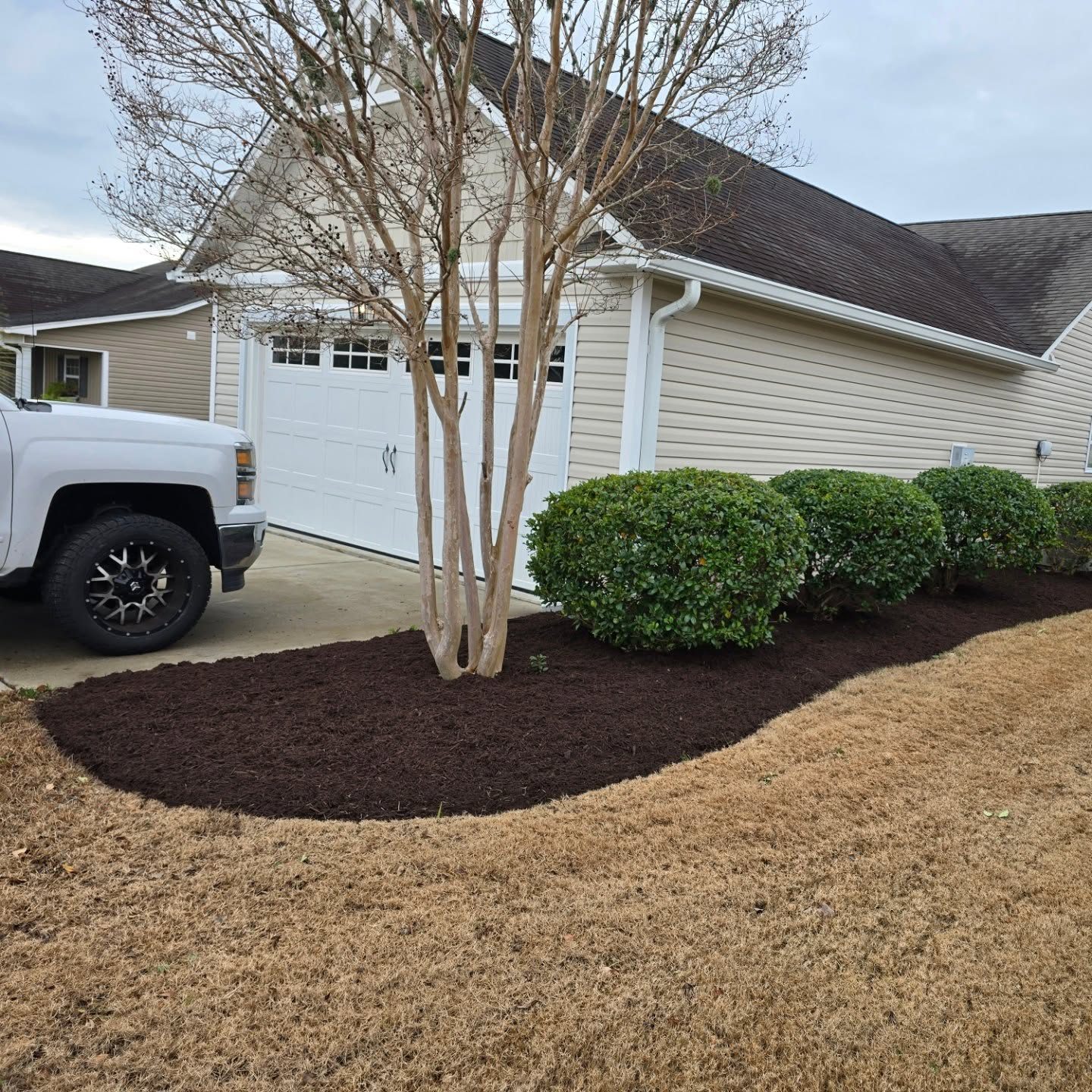 Fresh dark mulch installed in a landscape bed